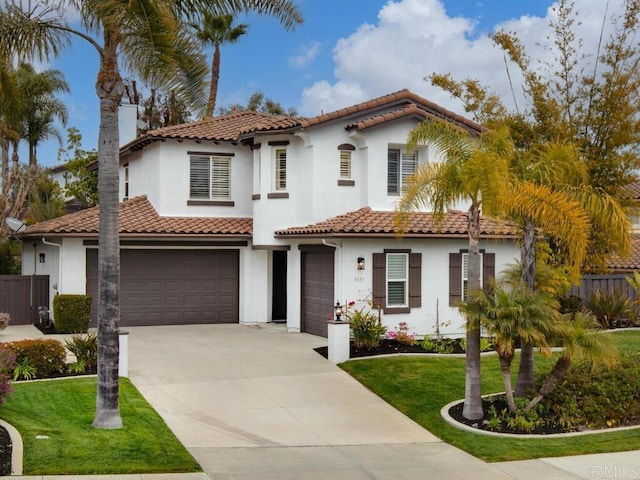 mediterranean / spanish-style home with a garage, fence, driveway, and a front lawn