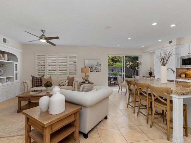 living area with a ceiling fan, light tile patterned flooring, visible vents, and recessed lighting