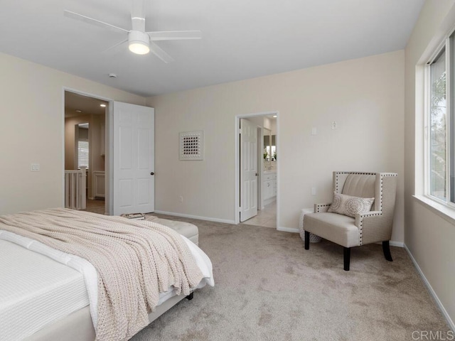 bedroom featuring carpet floors, baseboards, a ceiling fan, and ensuite bathroom