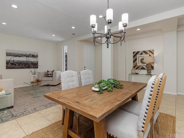 dining space featuring light tile patterned floors, an inviting chandelier, baseboards, and recessed lighting