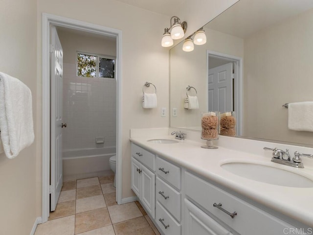 full bath with double vanity, toilet, a sink, and tile patterned floors