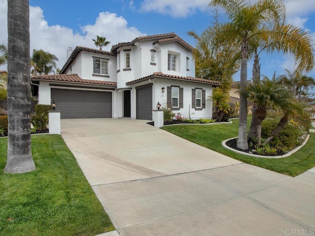 mediterranean / spanish-style house featuring driveway, a tile roof, a front lawn, and stucco siding