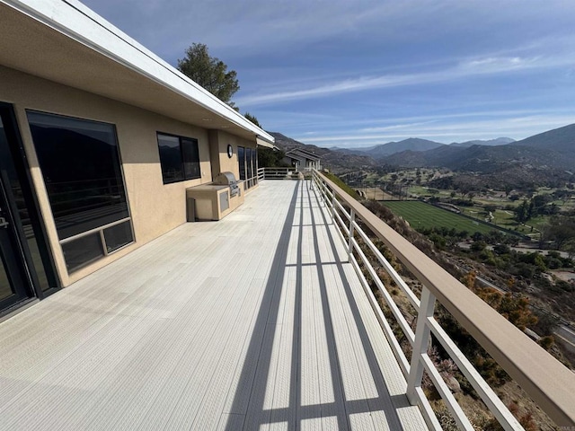 deck featuring a mountain view and grilling area