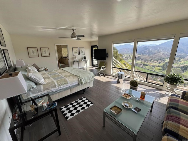 bedroom featuring access to outside, a ceiling fan, and hardwood / wood-style flooring