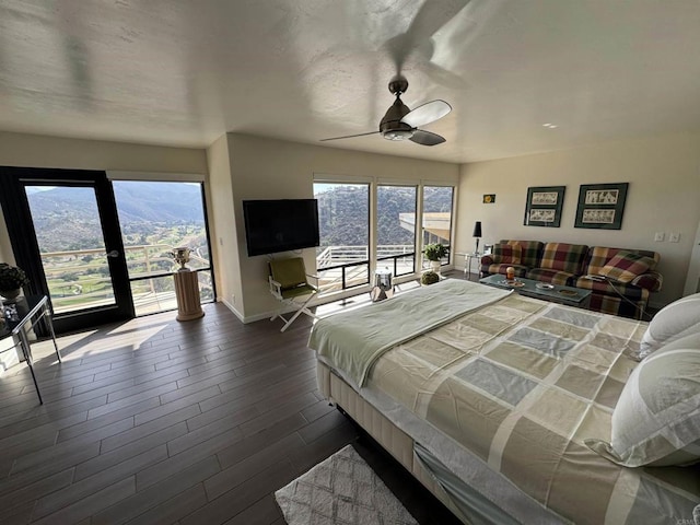bedroom featuring dark wood-type flooring, access to outside, baseboards, and a ceiling fan