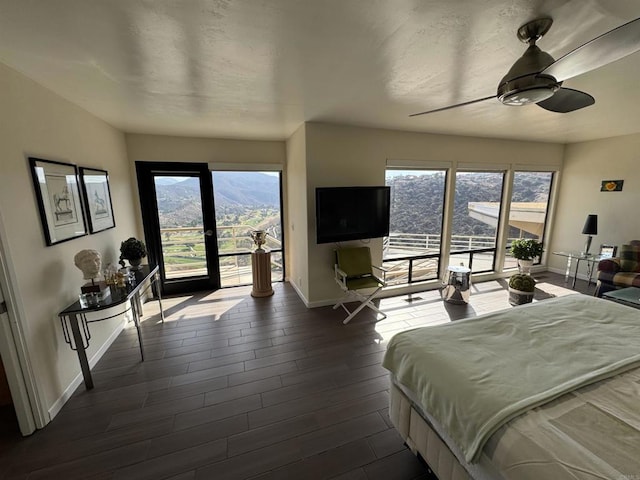 bedroom with access to exterior, ceiling fan, baseboards, and dark wood finished floors