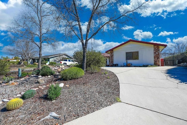 view of side of home with stone siding