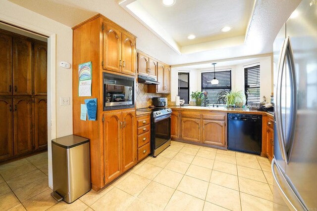16233 Oakley Rd, Ramona, CA 92065 - kitchen with a raised ceiling, brown cabinets, under cabinet range hood, and black appliances