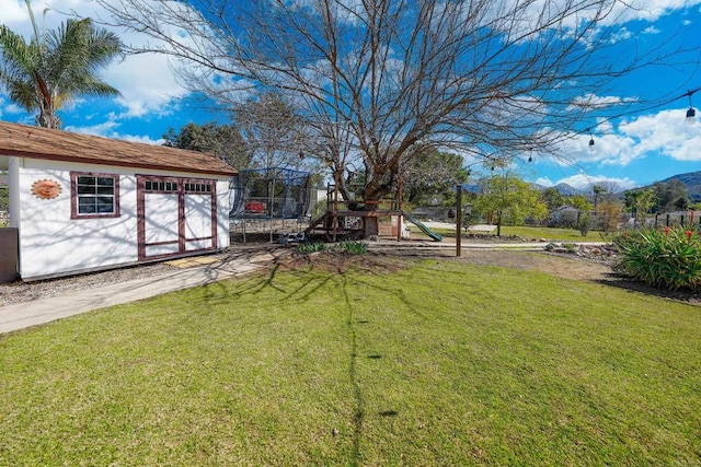 16233 Oakley Rd, Ramona, CA 92065 - view of yard featuring a trampoline, a playground, a storage unit, fence, and an outdoor structure