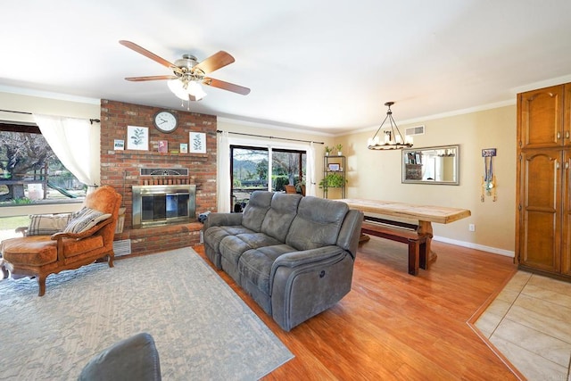 16233 Oakley Rd, Ramona, CA 92065 - living room with light wood-style flooring, a fireplace, and crown molding