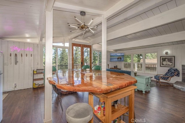 dining space featuring lofted ceiling with beams, hardwood / wood-style flooring, plenty of natural light, and wood ceiling