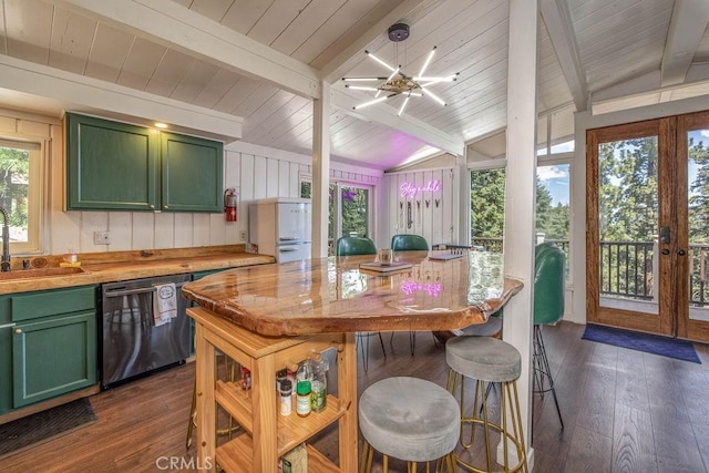 kitchen with dark wood finished floors, green cabinetry, dishwashing machine, vaulted ceiling with beams, and a sink