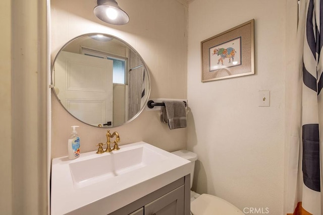 full bathroom with vanity and toilet