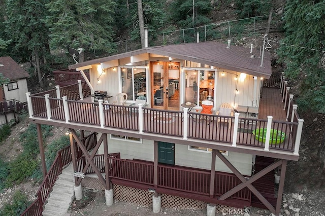 rear view of house with stairway and a deck