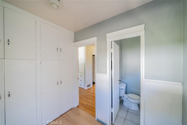 interior space featuring toilet and wood finished floors