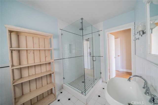 full bathroom with a tub, tile patterned flooring, a sink, and a shower stall