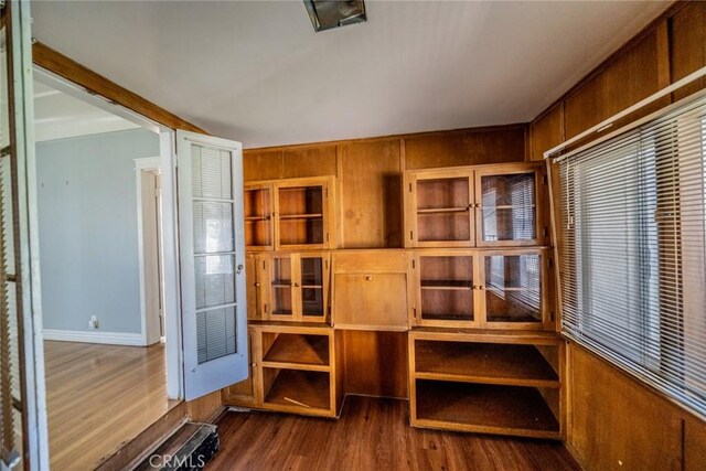 interior space featuring baseboards and wood finished floors