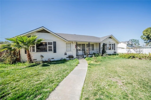 ranch-style house featuring a front lawn, crawl space, and fence