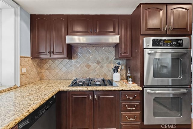 kitchen featuring dishwashing machine, under cabinet range hood, tasteful backsplash, and stainless steel double oven