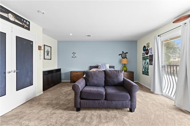 living area featuring carpet floors, recessed lighting, french doors, and visible vents