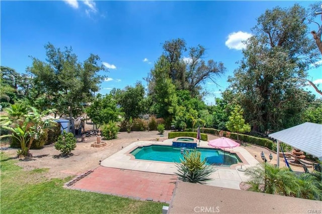 view of pool featuring a patio area and a pool with connected hot tub