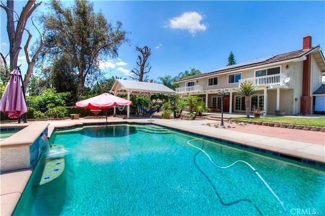 view of swimming pool featuring a patio area, a pool with connected hot tub, and french doors