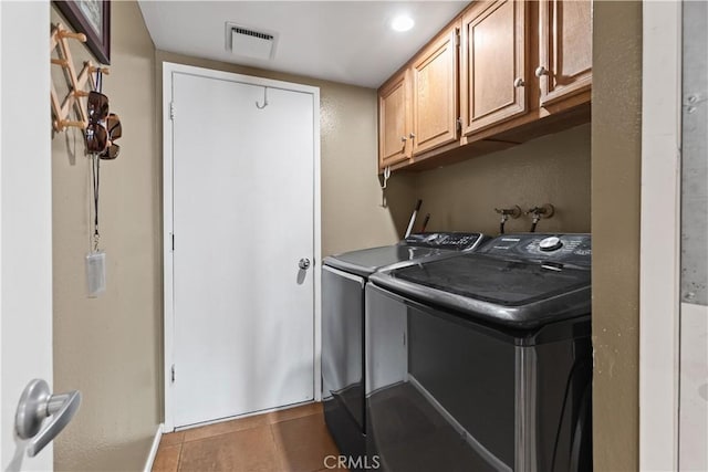 washroom featuring cabinet space, visible vents, baseboards, independent washer and dryer, and tile patterned flooring