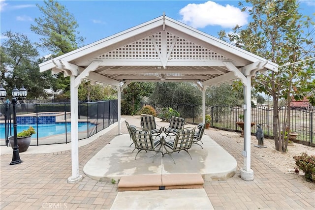 view of patio / terrace featuring a gazebo, fence, and a fenced in pool