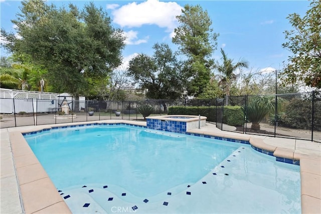 view of swimming pool with a pool with connected hot tub and fence