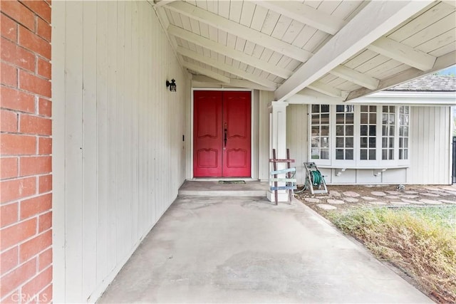 entrance to property featuring brick siding