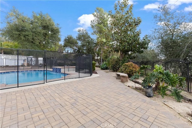 view of pool featuring fence, a fenced in pool, and a patio