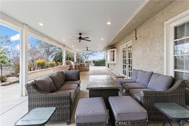 view of patio / terrace with french doors, fence, an outdoor living space, and ceiling fan