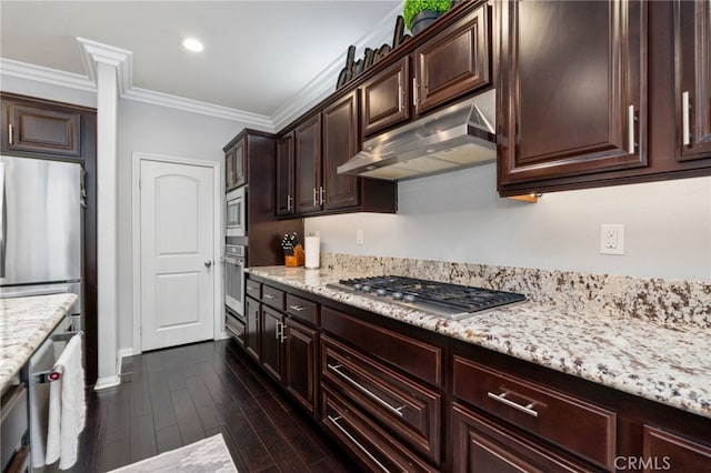 kitchen featuring light stone counters, under cabinet range hood, ornamental molding, appliances with stainless steel finishes, and dark wood-style floors