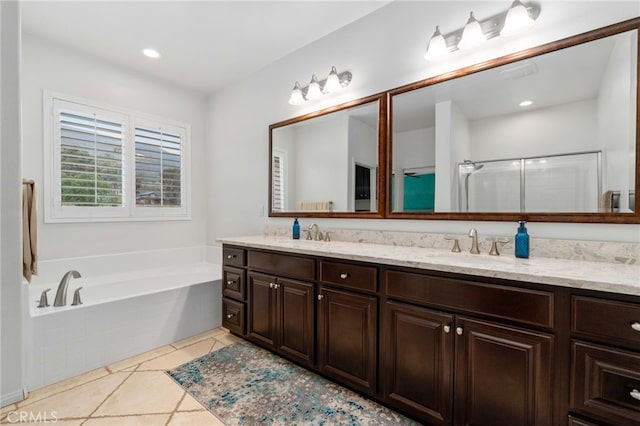 full bathroom featuring a stall shower, a garden tub, a sink, and double vanity