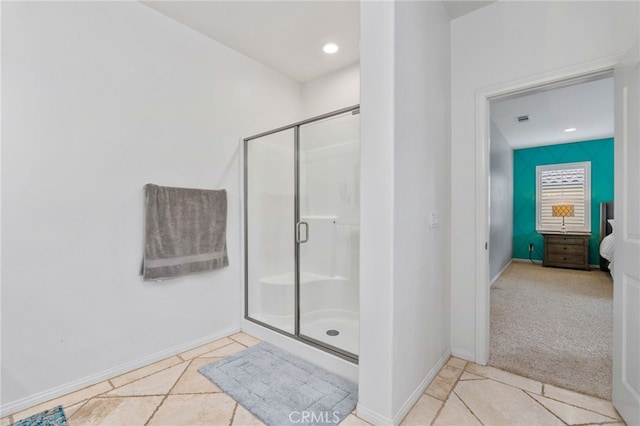 full bathroom featuring a stall shower, tile patterned flooring, and baseboards