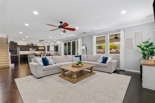 living room with dark wood-type flooring, recessed lighting, and crown molding