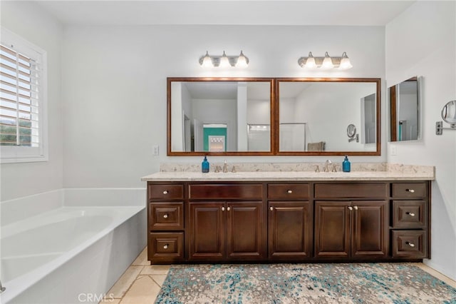 full bathroom featuring double vanity, a sink, a bath, and tile patterned floors