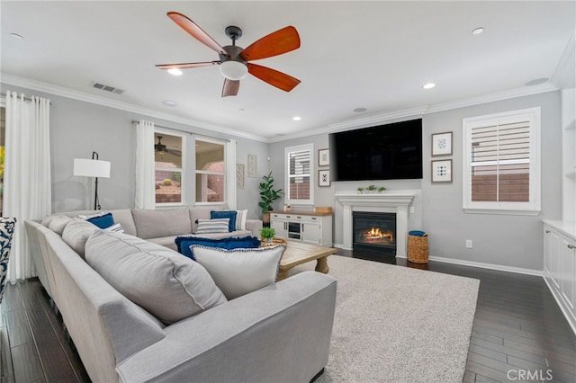 living room with baseboards, visible vents, dark wood-style flooring, and ornamental molding