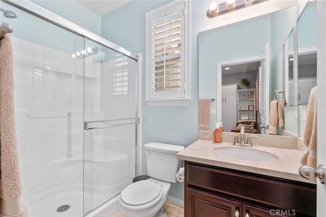 full bath featuring a stall shower, vanity, and toilet