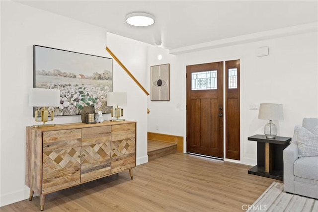 entryway with wood finished floors and baseboards