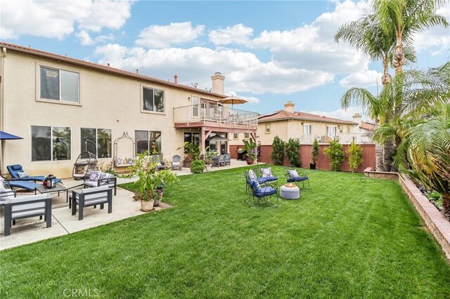 25 Vista Toscana, Lake Elsinore, CA 92532 - rear view of house with a balcony, a patio area, an outdoor living space, a chimney, and stucco siding