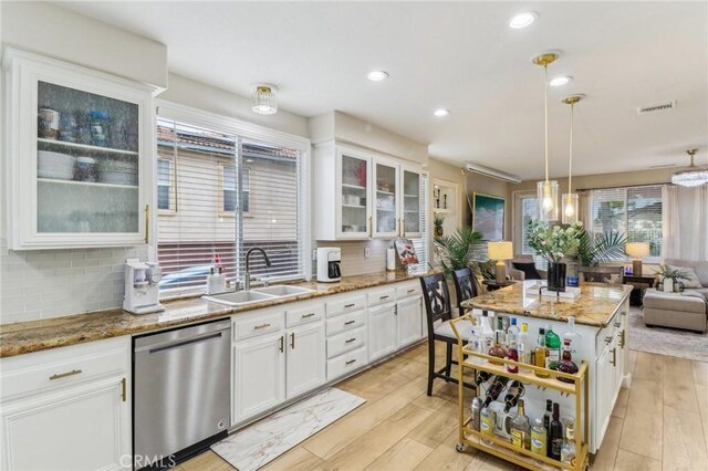 25 Vista Toscana, Lake Elsinore, CA 92532 - kitchen with dishwasher, a sink, tasteful backsplash, white cabinetry, and open shelves