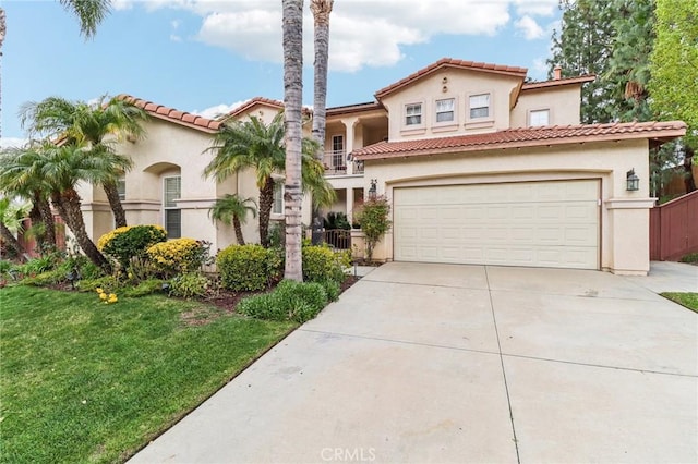 mediterranean / spanish home with stucco siding, a balcony, and concrete driveway