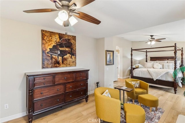 25 Vista Toscana, Lake Elsinore, CA 92532 - bedroom with light wood-type flooring, arched walkways, baseboards, and a ceiling fan