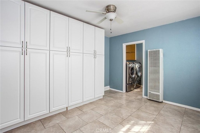 unfurnished bedroom with ceiling fan, baseboards, a heating unit, and washing machine and clothes dryer