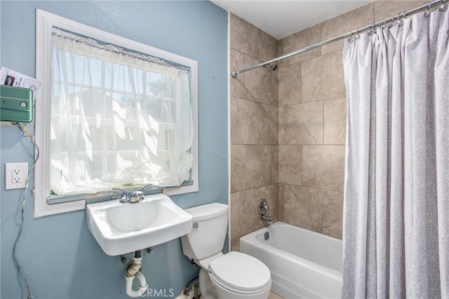 full bathroom with a sink, toilet, and shower / bath combination with curtain