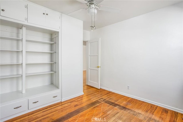 unfurnished bedroom with a closet, baseboards, a ceiling fan, and light wood finished floors