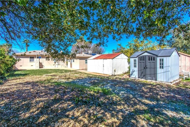 view of yard with a storage shed and an outbuilding