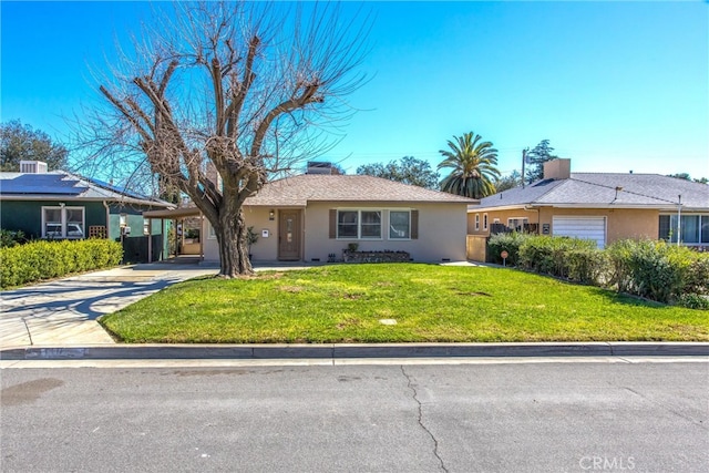 ranch-style home with a front lawn, concrete driveway, a carport, and stucco siding