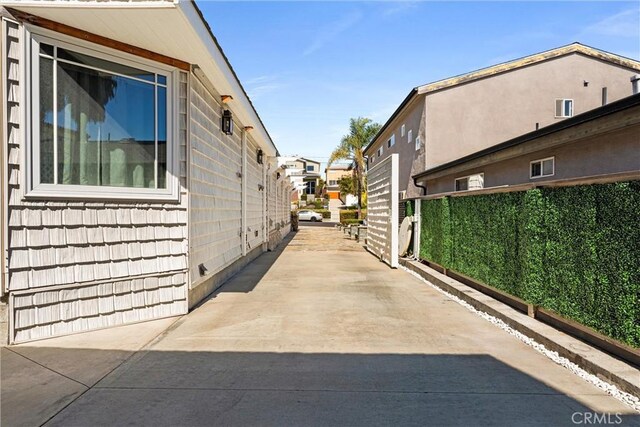 view of home's exterior with fence and a patio area